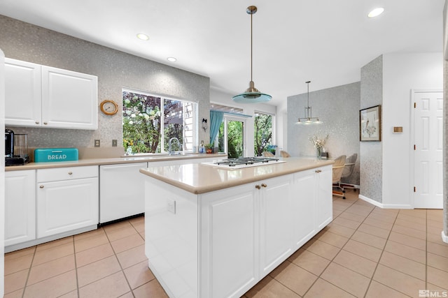 kitchen featuring decorative light fixtures, dishwasher, stainless steel gas cooktop, a center island, and white cabinetry