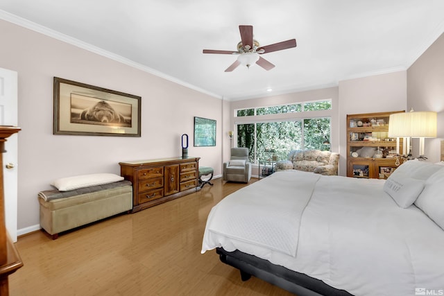 bedroom with hardwood / wood-style floors, ceiling fan, and ornamental molding