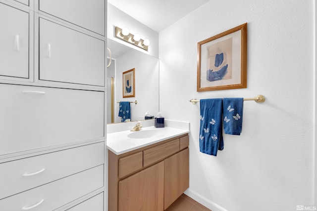 bathroom featuring tile patterned flooring and vanity