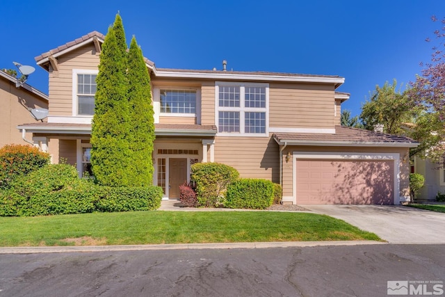 view of front of house with a front lawn and a garage