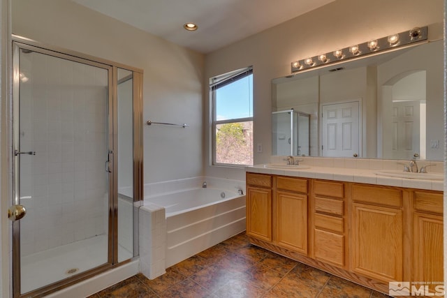 bathroom featuring vanity and shower with separate bathtub