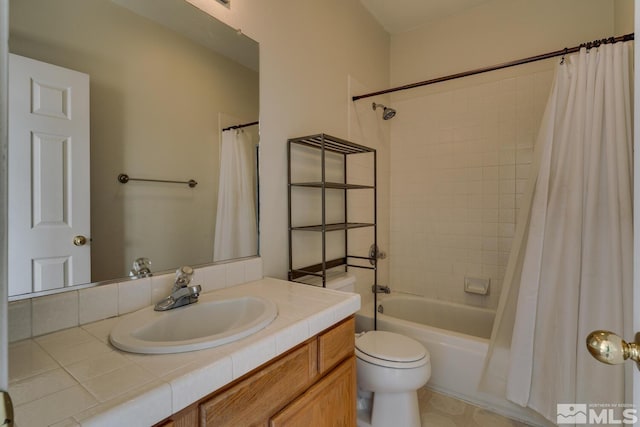 full bathroom featuring vanity, toilet, and shower / tub combo with curtain