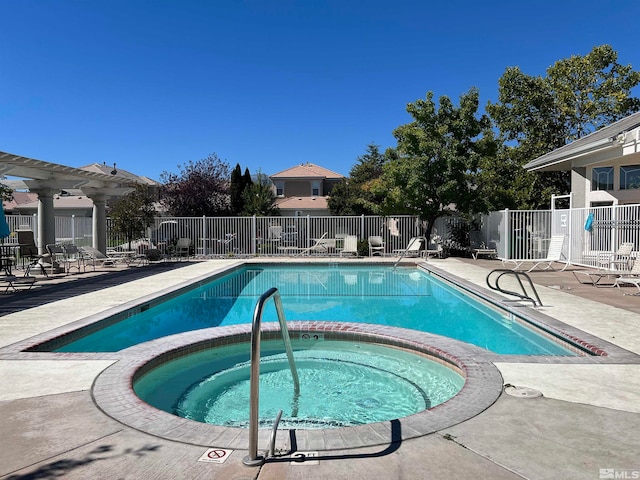 view of pool with a patio and a hot tub