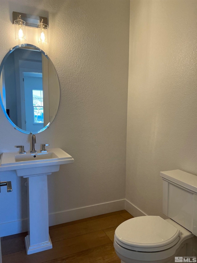 bathroom featuring toilet and hardwood / wood-style flooring