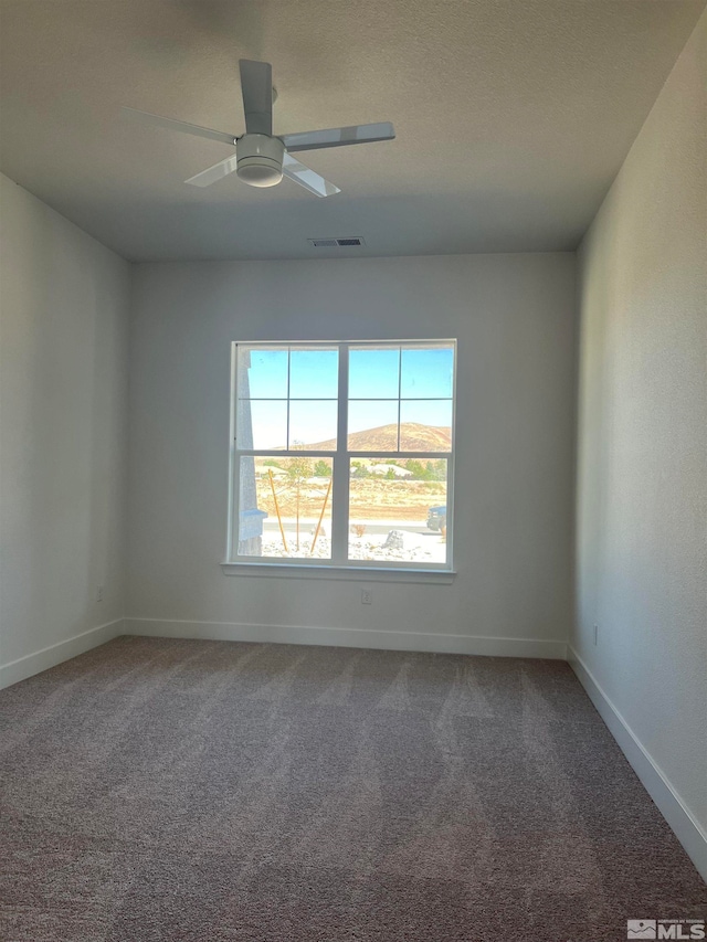 carpeted empty room featuring ceiling fan