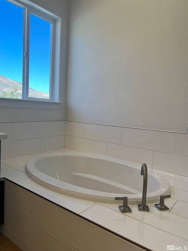 bathroom with tiled bath