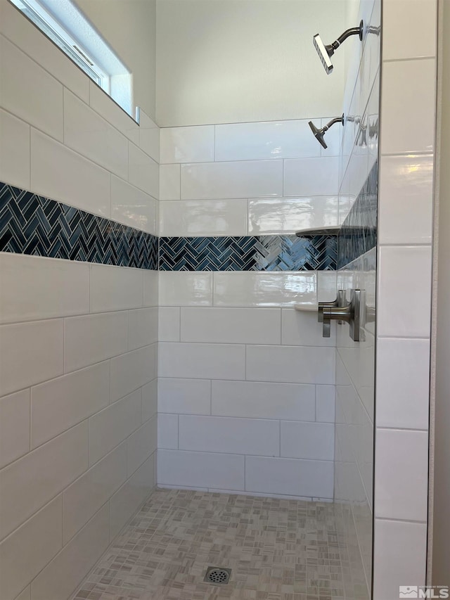 bathroom with tiled shower