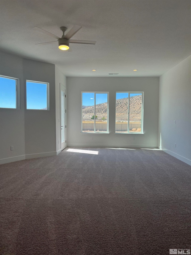 carpeted empty room with ceiling fan