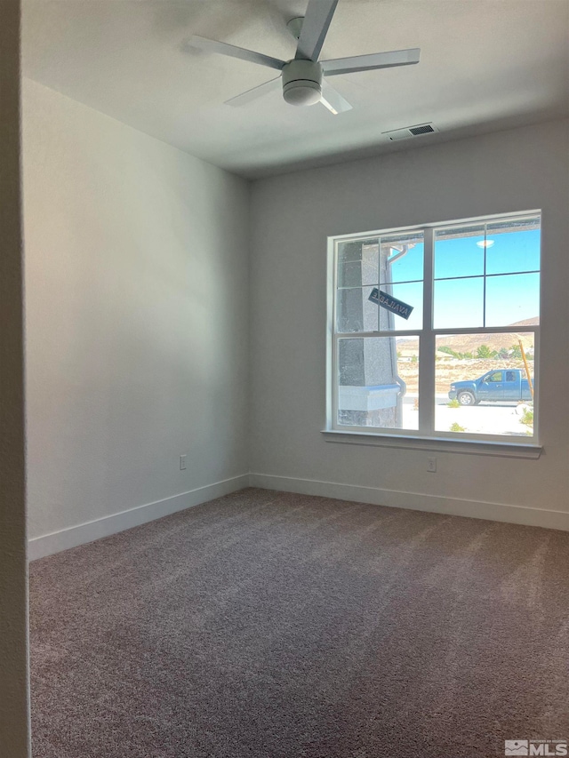 carpeted empty room featuring ceiling fan