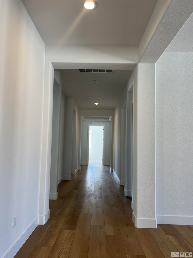 hall with hardwood / wood-style flooring