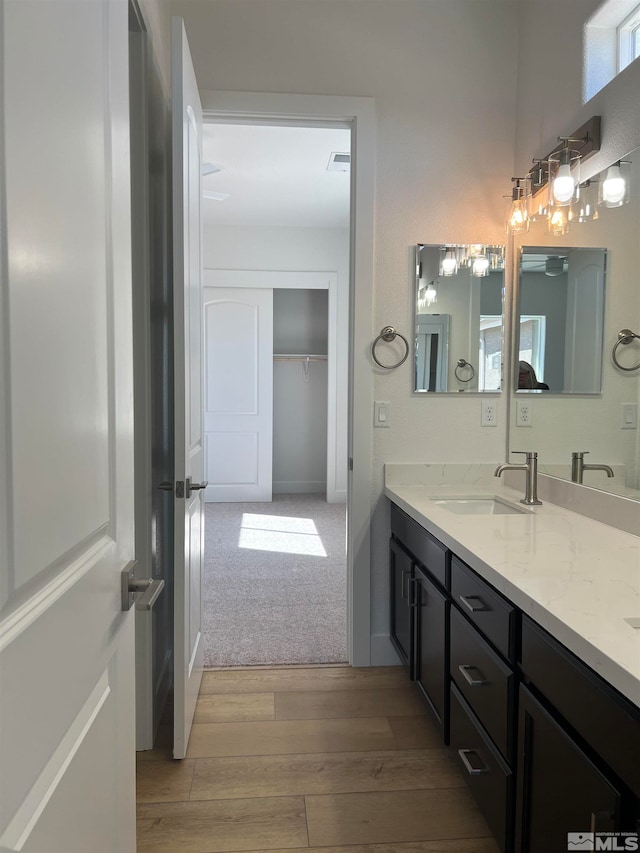 bathroom with vanity and hardwood / wood-style floors