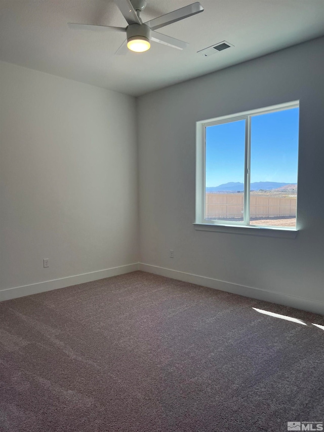 spare room featuring ceiling fan and carpet flooring