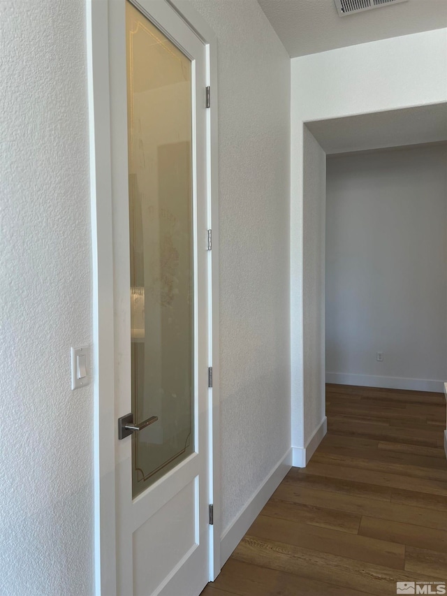 hallway with hardwood / wood-style floors