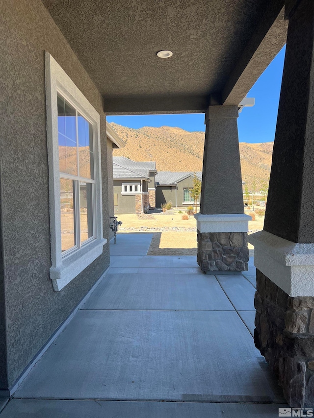 view of patio / terrace featuring a mountain view