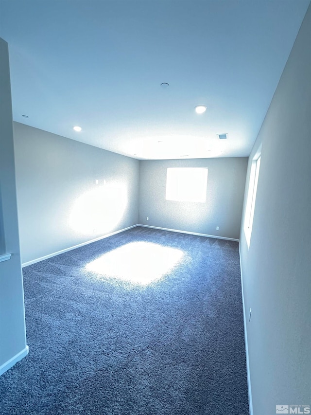 empty room with dark colored carpet