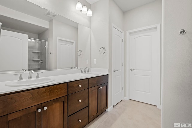 bathroom with vanity, walk in shower, and tile patterned flooring