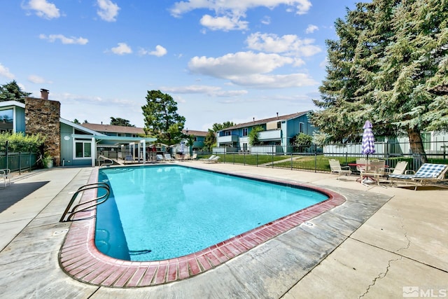 view of swimming pool with a patio area