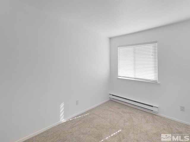 carpeted spare room with baseboard heating