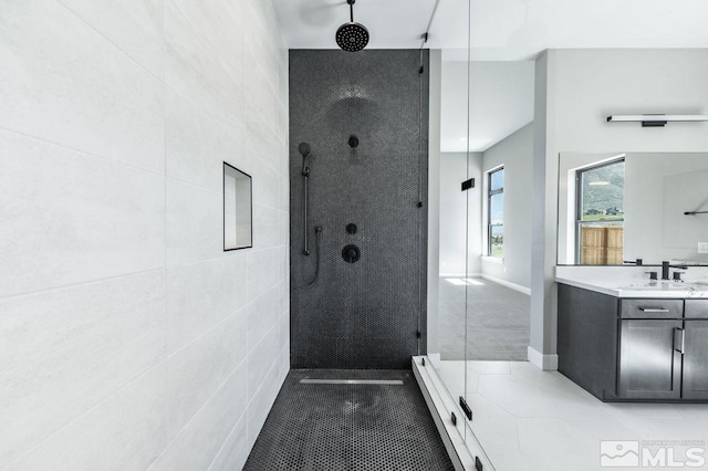 bathroom featuring vanity and tiled shower