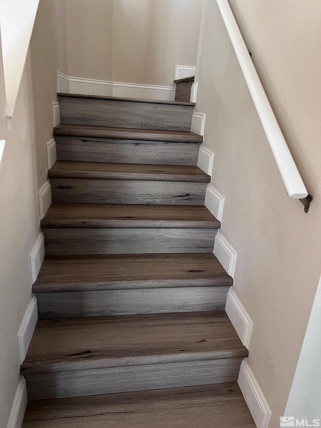 staircase with hardwood / wood-style flooring