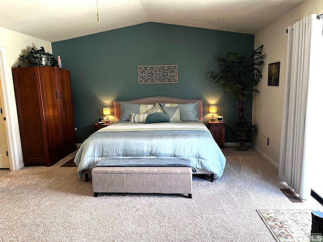 carpeted bedroom with lofted ceiling