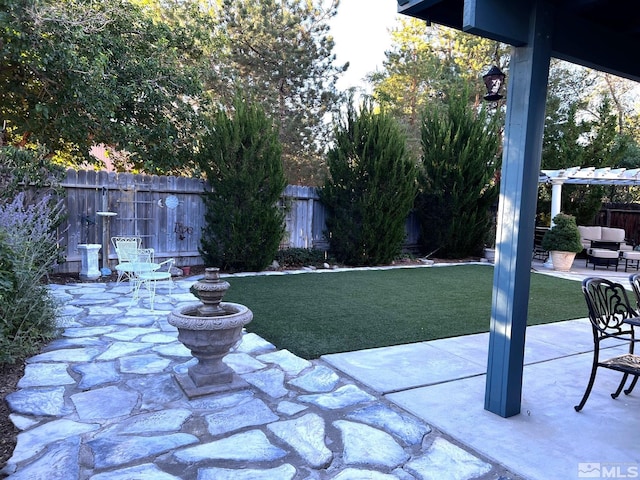 view of yard with a pergola and a patio