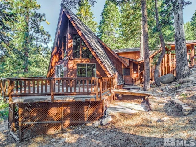 back of house with a wooden deck