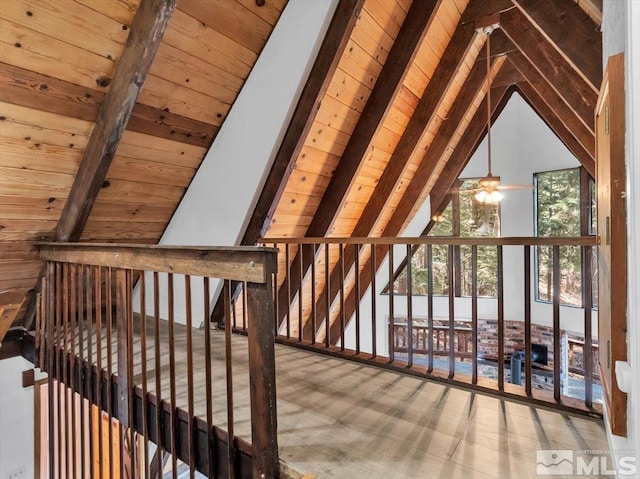 interior space featuring lofted ceiling with beams and wooden ceiling