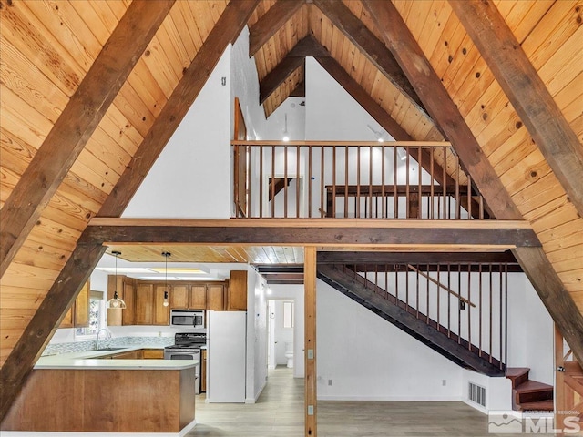 stairway featuring wood ceiling, hardwood / wood-style floors, and beamed ceiling