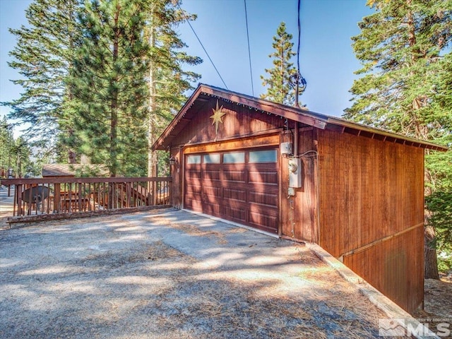 garage featuring wood walls