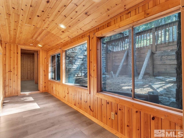 unfurnished sunroom featuring wood ceiling