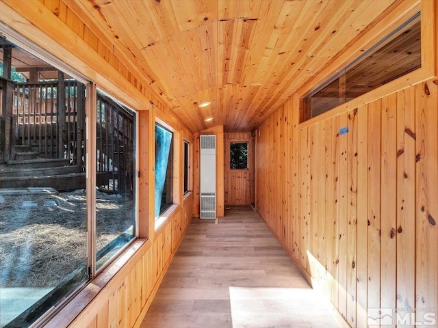 unfurnished sunroom with wood ceiling