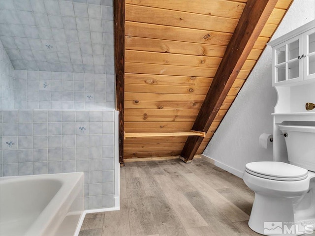 bathroom with toilet, hardwood / wood-style floors, and a washtub