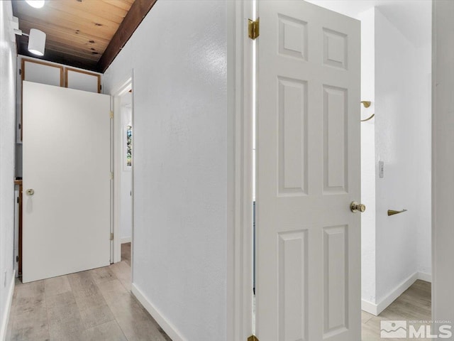 corridor featuring wood ceiling and light hardwood / wood-style floors