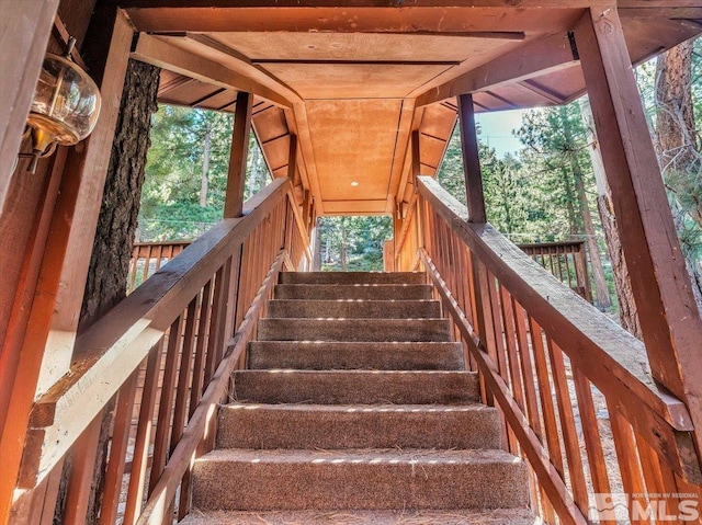 staircase with vaulted ceiling and a healthy amount of sunlight