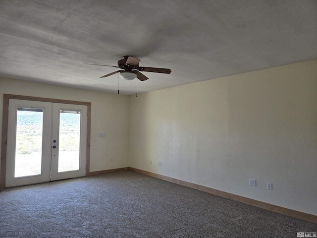 carpeted spare room with a ceiling fan, french doors, and baseboards