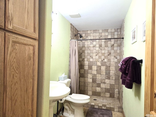 bathroom featuring toilet and a stall shower