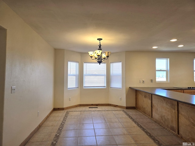 unfurnished dining area featuring light tile patterned flooring, a notable chandelier, recessed lighting, and baseboards