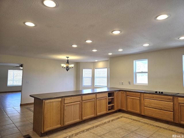 kitchen featuring dark countertops, black electric cooktop, a peninsula, and recessed lighting