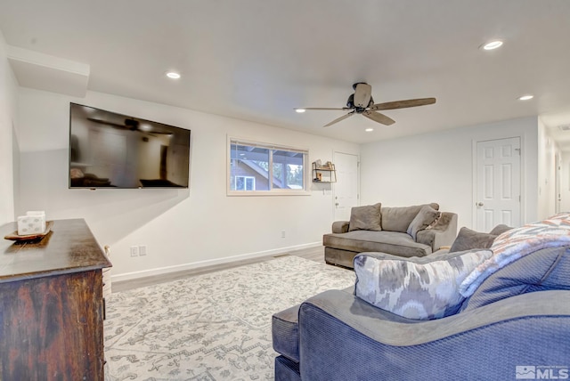 living room with ceiling fan and light hardwood / wood-style flooring