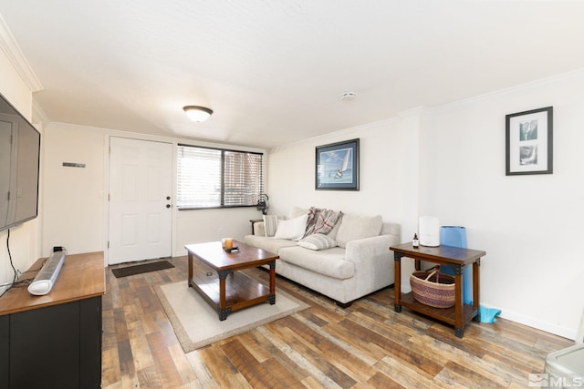 living room with ornamental molding and dark hardwood / wood-style floors