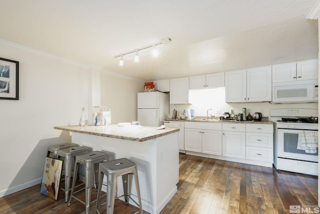 kitchen with a kitchen breakfast bar, white appliances, dark wood-type flooring, and white cabinets