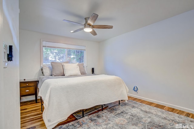 bedroom with ceiling fan and wood-type flooring