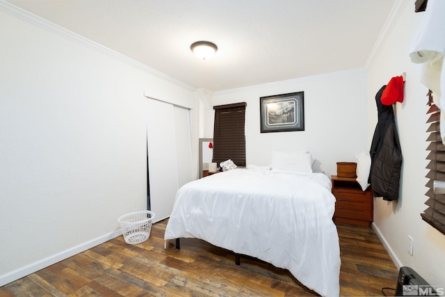 bedroom featuring ornamental molding and dark wood-type flooring