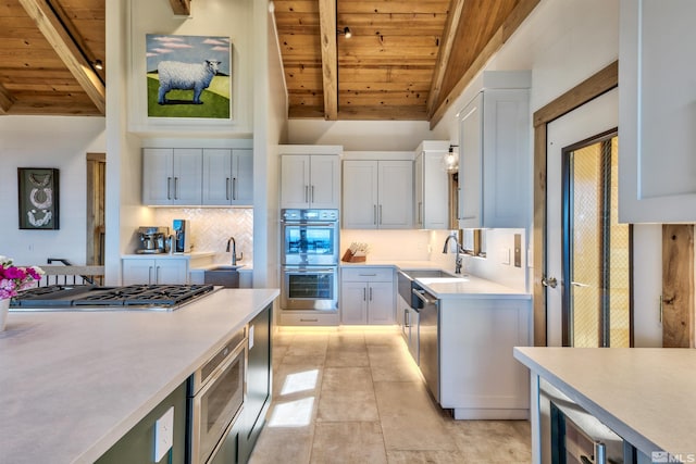 kitchen with white cabinets, appliances with stainless steel finishes, and wooden ceiling