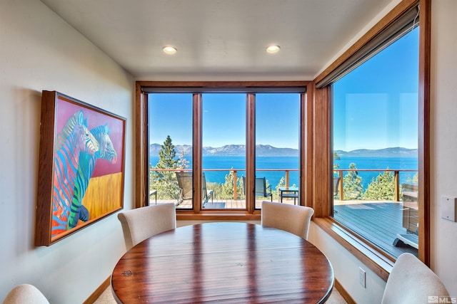 dining space featuring a water and mountain view