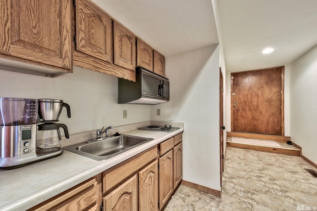 kitchen with stainless steel cooktop and sink