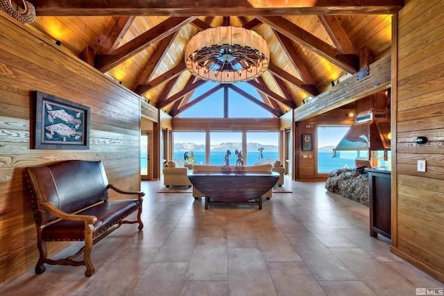 interior space featuring high vaulted ceiling, wood walls, beamed ceiling, and wooden ceiling