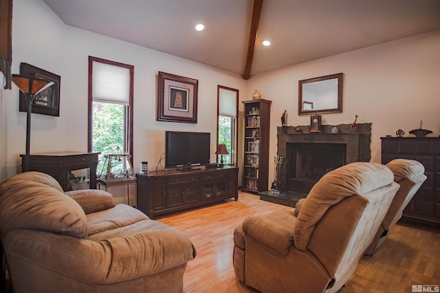 living room featuring vaulted ceiling with beams and hardwood / wood-style flooring