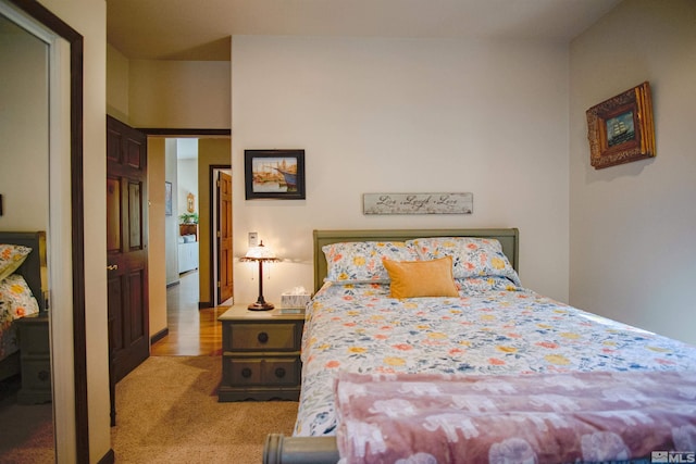 bedroom featuring light colored carpet